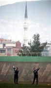 16 November 1999; Goalkeeper Dean Kiely, left, and goalkeeping coach Packie Bonner warm-up, with a view of a local mosque behind, during a Republic of Ireland training session at Veledrom Stadium in Bursa, Turkey. Photo by Brendan Moran/Sportsfile *** Local Caption ***