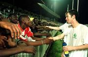 2 April 1999;  Keith Doyle greets local school children after a Republic of Ireland U20 Squad training sesssion at the Liberty Stadium in Ibadan, Nigeria. Photo by David Maher/Sportsfile