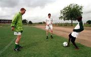 1 April 1999; Thomas Heary, left, and Richie Baker get in some practice with a local schoolboy during a Republic of Ireland U20 Squad training sesssion at the Liberty Stadium in Ibadan, Nigeria. Photo by David Maher/Sportsfile