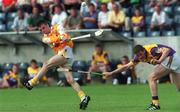 24 July 1999; Michael McClements of Antrim in action against Anthohy O'Leary of Wexford during the All-Ireland Minor Hurling Championship Quarter-Final match between Antrim and Wexford at Parnell Park in Dublin. Photo by Ray Lohan/Sportsfile