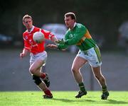 30 October 1999; Mike Hassett of Kerry passess under pressure from Philip Clifford of Cork during the Church & General National Football League Division 1A Round 1 match between Cork and Kerry at Páirc Uí Rinn in Cork. Photo by Brendan Moran/Sportsfile
