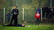 16 November 1999; Goalkeeper Dean Kiely, ground, with goalkeeping coach Packie Bonner during a Republic of Ireland training session at Veledrom Stadium in Bursa, Turkey. Photo by David Maher/Sportsfile *** Local Caption ***