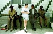 13 April 1999; Republic of Ireland player Robbie Keane chats to local people outside the team hotel, Tahir Guest Palace, in Kano, Nigeria. Photo by David Maher/Sportsfile