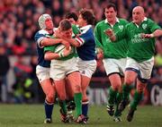 4 March 2000; Ronan O'Gara of Ireland, supported by team-mates Keith Wood, right, and Anthony Foley is tackled by Mauro Bergamasco, left, and Diego Dominguez of Italy during the Lloyds TSB 6 Nations match between Ireland and Italy at Lansdowne Road in Dublin. Photo by Damien Eagers/Sportsfile