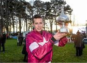28 December 2014; Jockey Bryan Cooper with the Lexus Chase Perpetual Cup after winning the Lexus Steeplechase aboard Road To Riches. Leopardstown Christmas Festival, Leopardstown, Co. Dublin. Photo by Sportsfile