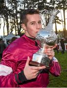 28 December 2014; Jockey Bryan Cooper kisses the Lexus Chase Perpetual Cup after winning the Lexus Steeplechase aboard Road To Riches. Leopardstown Christmas Festival, Leopardstown, Co. Dublin. Photo by Sportsfile