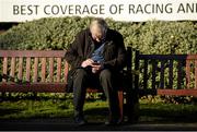 29 December 2014; Sean McConnell from Castleblaney, Co. Monaghan looks up his racecard before the days races. Leopardstown Christmas Festival, Leopardstown, Co. Dublin. Picture credit: Barry Cregg / SPORTSFILE