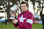 29 December 2014; Jockey Bryan Cooper holds up the winners trophy after he rode Don Poli to win the Topaz Novice Steeplechase. Leopardstown Christmas Festival, Leopardstown, Co. Dublin. Picture credit: Barry Cregg / SPORTSFILE