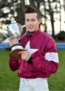 29 December 2014; Jockey Bryan Cooper holds up the winners trophy after he rode Don Poli to win the Topaz Novice Steeplechase. Leopardstown Christmas Festival, Leopardstown, Co. Dublin. Picture credit: Barry Cregg / SPORTSFILE
