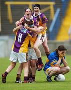 25 August 2007; A dejected Claire Carroll, Tipperary, crouches down as Wexford players celebrate at the final whistle. TG4 All-Ireland Intermediate Ladies Football Championship Semi-Final, Tipperary v Wexford, O'Moore Park, Portlaoise. Photo by Sportsfile  *** Local Caption ***
