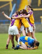 25 August 2007; A dejected Claire Carroll, Tipperary, on the ground as Wexford players celebrate at the final whistle. TG4 All-Ireland Intermediate Ladies Football Championship Semi-Final, Tipperary v Wexford, O'Moore Park, Portlaoise. Photo by Sportsfile  *** Local Caption ***