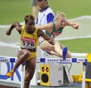 28 August 2007; Ireland's Derval O'Rourke clears a hurdle behind Vonette Dixon of Jamaica, 578, in her semi-final of the Women's 100m Hurdles where she finished 8th in a time of 12.98. The 11th IAAF World Championships in Athletics, Nagai Stadium, Osaka, Japan. Picture credit: Brendan Moran / SPORTSFILE *** Local Caption ***