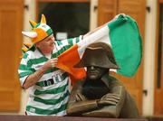 7 September 2007; Republic of Ireland supporter Peter Gannon, from Inchicore, Dublin, wraps a tricolour over a statue in the centre of Bratisalvia. The Republic of Ireland play Slovakia on Sunday, weather permitting. Bratislava, Slovakia. Picture credit; David Maher / SPORTSFILE