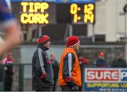 11 January 2015; Cork manager Brian Cuthbert, left, and selector Ciaran O'Sullivan look on during the final moments of the game as the eventual final score is displayed on the scoreboard. McGrath Cup Quarter-Final, Tipperary v Cork, Clonmel Sportsfield, Clonmel, Co. Tipperary. Picture credit: Diarmuid Greene / SPORTSFILE