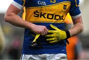 11 January 2015; A Tipperary player removes their gloves after the game. McGrath Cup Quarter-Final, Tipperary v Cork, Clonmel Sportsfield, Clonmel, Co. Tipperary. Picture credit: Diarmuid Greene / SPORTSFILE