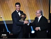 12 January 2015; Cristiano Ronaldo, Real Madrid and Portugal, is presented with FIFA Ballon d'Or by FIFA President Sepp Blatter. FIFA Ballon D'Or 2014. Kongresshaus, Zurich, Switzerland. Picture credit: David Maher / SPORTSFILE