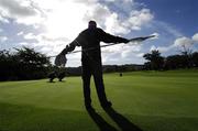 14 September 2007; George Nish, a caddy for Geoff Lenehan, Portmarnock G.C., Dublin, holds the flag as Banbridge's Alastair McCully and his caddy Johnny Ward line us a putt on the 5th during the Bulmers Senior Cup Semi-Finals. Bulmers Cups and Shields Finals 2007, Shandon Park Golf Club, Belfast, Co. Antrim. Picture credit: Ray McManus / SPORTSFILE