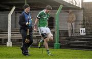 17 January 2015; Limerick's David Breen, alongside physio David Walsh, leaves the pitch using crutches after picking up an injury during the first half. Waterford Crystal Cup Quarter-Final, Limerick v Waterford. John Fitzgerald Park, Kilmallock, Co. Limerick. Picture credit: Diarmuid Greene / SPORTSFILE