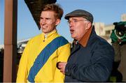 18 January 2015; Jockey Adrian Heskin with trainer Ted Walsh watch the replay of their race on the big screen after he rode Foxrock to win the BoyleSports Handicap Steeplechase. Leopardstown, Co. Dublin. Picture credit: Barry Cregg / SPORTSFILE