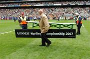 2 September 2007; A staff member removes the Guinness sponsorship sign after the team photographs. Guinness All-Ireland Senior Hurling Championship Final, Kilkenny v Limerick, Croke Park, Dublin. Picture Credit; Ray McManus / SPORTSFILE