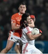 21 January 2015; Shay McGuigan, Tyrone, is tackled by  Niall McConville, Armagh. Dr. McKenna Cup Semi-Final, Armagh v Tyrone. Athletic Grounds, Armagh. Picture credit: Ramsey Cardy / SPORTSFILE