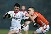 21 January 2015; Ronan O'Neill, Tyrone, is tackled by Mark Shields, Armagh. Dr. McKenna Cup Semi-Final, Armagh v Tyrone. Athletic Grounds, Armagh. Picture credit: Ramsey Cardy / SPORTSFILE