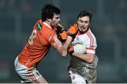21 January 2015; Shay McGuigan, Tyrone, is tackled by Aaron Findon, Armagh. Dr. McKenna Cup Semi-Final, Armagh v Tyrone. Athletic Grounds, Armagh. Picture credit: Ramsey Cardy / SPORTSFILE