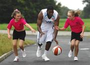 30 September 2007; Cheerleaders from 'Cheer Fusion' in Killister, Lauren Redmond, left, aged 11, from Raheny, and Niamh O'Connor, aged 12, from Portmarnock, try to get the ball of University of Ulster's Adrian Gross at the Basketball Ireland Domestic Season Launch 2007/08. University of Ulster are newcomers into the Men's Super League this year. Basketball Arena, Tallaght, Dublin. Photo by Sportsfile
