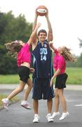 30 September 2007; Cheerleaders from 'Cheer Fusion' in Killister, Lauren Redmond, left, aged 11, from Raheny, and Niamh O'Connor, aged 12, from Portmarnock, try to get the ball from University of Ulster's Bryan Niemanh at the Basketball Ireland Domestic Season Launch 2007/08. University of Ulster are newcomers into the Men's Super League this year. Basketball Arena, Tallaght, Dublin. Photo by Sportsfile