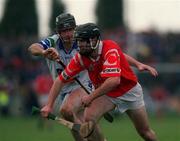 26 March 2000; Ben O'Connor of Cork in action against Tom Feeney of Waterford during the Church & General National Hurling League Division 1B Round 4 match between Waterford and Cork at Walsh Park in Waterford. Photo by Aoife Rice/Sportsfile