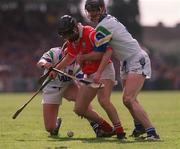 26 March 2000; Ben O'Connor of Cork is tackled by Tom Feeney, right and James O'Connor of Waterford during the Church & General National Hurling League Division 1B Round 4 match between Waterford and Cork at Walsh Park in Waterford. Photo by Aoife Rice/Sportsfile