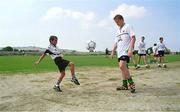 6 September 1999; 10 year old Neil Hales, from Malta, shows some of his skills to Damien Duff during a Republic of Ireland training session at Ta'Qali Stadium in Attard, Malta. Photo by David Maher/Sportsfile