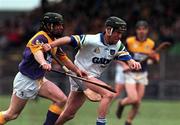 27 February 2000; Dave Bennett of Waterford is tackled by Sean Flood of Wexford during the Church & General National Hurling League Division 1B Round 2 match between Waterford and Wexford at Walsh Park in Waterford. Photo by Matt Browne/Sportsfile