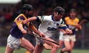 27 February 2000; Dave Bennett of Waterford in action against Sean Flood of Wexford during the Church & General National Hurling League Division 1B Round 2 match between Waterford and Wexford at Walsh Park in Waterford. Photo by Matt Browne/Sportsfile