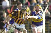 26 March 2000; Eddie Brennan of Kilkenny is tackled by Eamon Corcoran, right, and Brian Horgan of Tipperary during the Church & General National Hurling League Division 1B Round 4 match between Tipperary and Kilkenny at Nowlan Park in Kilkenny. Photo by Ray McManus/Sportsfile