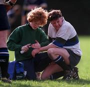 11 March 2000; Eoin McCormack of Wanderers is attended to by physio Sharon Kelly during the AIB All-Ireland League Division 2 match between Wanderers and Dolphin at Wanderers RFC in Merrion Road, Dublin. Photo by Ray McManus/Sportsfile