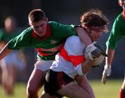 20 November 1999; Fionan Kelleher of UCC in action against Aidan Power of Rathgormack during the AIB Munster Senior Club Football Championship Semi-Final match between Rathgormack and UCC at Páirc Uí Rinn in Cork. Photo by Damien Eagers/Sportsfile