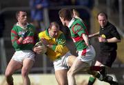 25 March 2000; Jody Devine of Meath in action against Kenneth Mortimer, left, and James Nallen of Mayo during the Church & General National Football League Division 1B Round 6 match between Meath and Mayo at Páirc Tailteann in Navan, Meath. Photo by Damien Eagers/Sportsfile