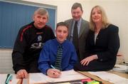 15 January 2000; 15 year-old John Fitzgerald, from Dublin, signs for Blackburn Rovers watched by his parents Miriam and Peter and Bobby Downes, Director of Blackburn Rovers Youth Academy at the new Youth Academy at Ewood Park in Blackburn, England. Photo by David Maher/Sportsfile