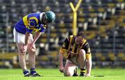 26 March 2000; Andy Comerford of Kilkenny uses the hurley of David Kennedy of Tipperary during the Church & General National Hurling League Division 1B Round 4 match between Tipperary and Kilkenny at Nowlan Park in Kilkenny. Photo by Ray McManus/Sportsfile
