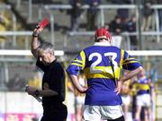 26 March 2000; Referee Pat O'Connor issues the red card to Eddie Tucker of Tipperary during the Church & General National Hurling League Division 1B Round 4 match between Tipperary and Kilkenny at Nowlan Park in Kilkenny. Photo by Ray McManus/Sportsfile