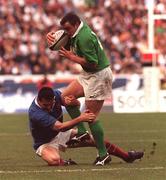 19 March 2000; Rob Henderson of Ireland is tackled by Cedric Desbrosse of France during the Six Nations Rugby Championship match between France and Ireland at the Stade de France in Paris, France. Photo by Ray Lohan/Sportsfile *** Local Caption ***