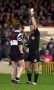 12 December 1999. Referee Brian White shows a yellow card to Philip Smith of Doonbeg during the AIB Munster Senior Club Football Championship Final match between UCC and Doonbeg at the Gaelic Grounds in Limerick. Photo by Brendan Moran/Sportsfile