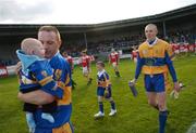 30 September 2007; Padraig Jones, captain of Dromard, holds his four month old baby son, Killian, during the parades of the two teams. Longford Senior Football Championship Final, Dromard v Colmcille, Pearse Park, Longford. Picture credit; David Maher / SPORTSFILE
