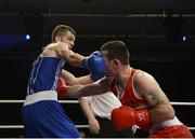 23 January 2015: Adam Nolan, left, Bray Boxing Club,  lands a punch on John Joe Joyce, St. Michael's Boxing Club, Athy, during their 69kg bout. National Elite Boxing Championship Finals, National Stadium, Dublin. Picture credit: Ray Lohan / SPORTSFILE