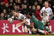 24 January 2015; Darren Cave, Ulster, dives over to score his third try of the game despite the tackle of Vereniki Gonevar, Leicester Tigers. European Rugby Champions Cup 2014/15, Pool 3, Round 6, Ulster v Leicester Tigers, Kingspan Stadium, Ravenhill Park, Belfast, Co. Antrim. Picture credit: Ramsey Cardy / SPORTSFILE
