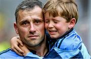 23 January 2015; Exhibition image from Sportsfile at the Professional Photographers Association of Ireland - Photographer of the Year Awards 2015. Brendan Moran - Finalist in Sports Feature  31 August 2014; A tearful Alan Brogan of Dublin leaves the pitch with his son Jamie after defeat by Donegal. GAA Football All Ireland Senior Championship, Semi-Final, Dublin v Donegal, Croke Park, Dublin. Picture credit: Brendan Moran / SPORTSFILE