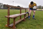 25 January 2015; Roscommon captain Niall Carty wipes away rain water from the team bench before the traditional team photograph. FBD Connacht League Final, Roscommon v Galway, Kiltoom, Co. Roscommon. Picture credit: David Maher / SPORTSFILE