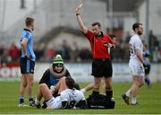 25 January 2015; Hugh Lynch, Kildare, is shown the yellow card by referee David Gough as he receives treatment for an injury. Bord na Mona O'Byrne Cup Final, Kildare v Dublin, St Conleth's Park, Newbridge, Co. Kildare. Picture credit: Piaras Ó Mídheach / SPORTSFILE