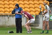 25 January 2015; Galway's Joe Canning receives treatment from physio Dave Hanley after dislocating his finger during the game. Bord na Mona Walsh Cup Group 4, Round 3, Offaly v Galway, O'Connor Park, Tullamore, Co. Offaly. Picture credit: Matt Browne / SPORTSFILE
